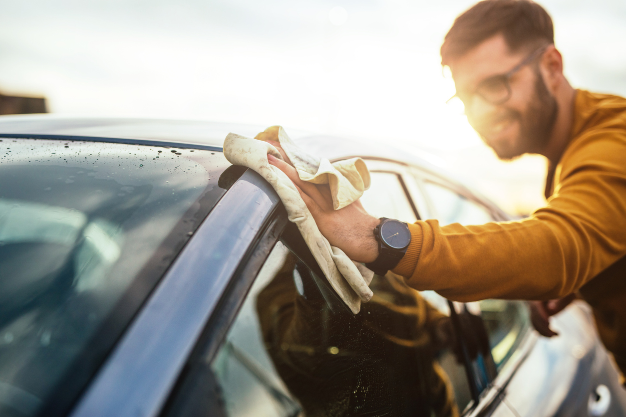 A young man excited to keep his car clean like a pro